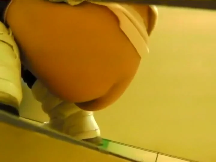 Asian girl gets filmed in a public toilet