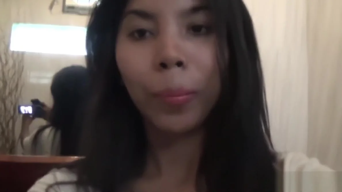 Sexy brunette Asian babe fools around with the camera